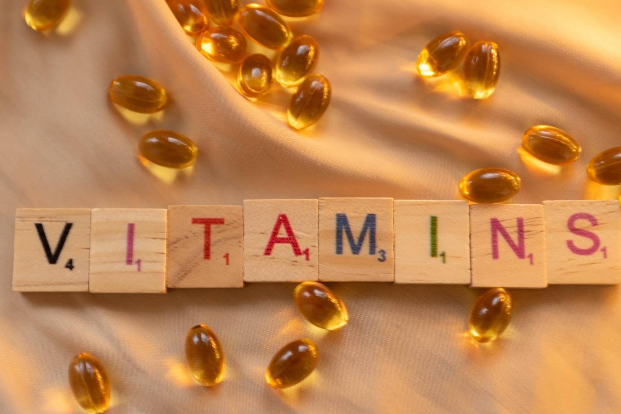 Vitamine and pills on satin background